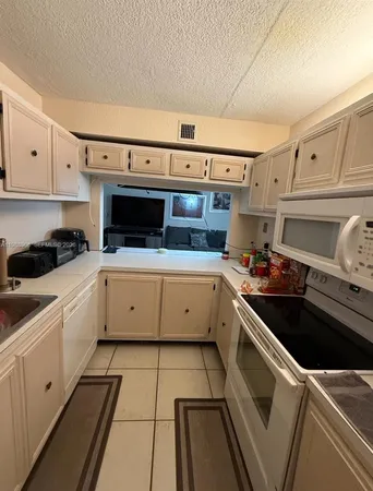 a kitchen with a stove a sink and a refrigerator
