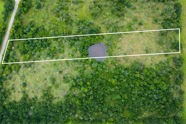a view of a fence and yard from a window