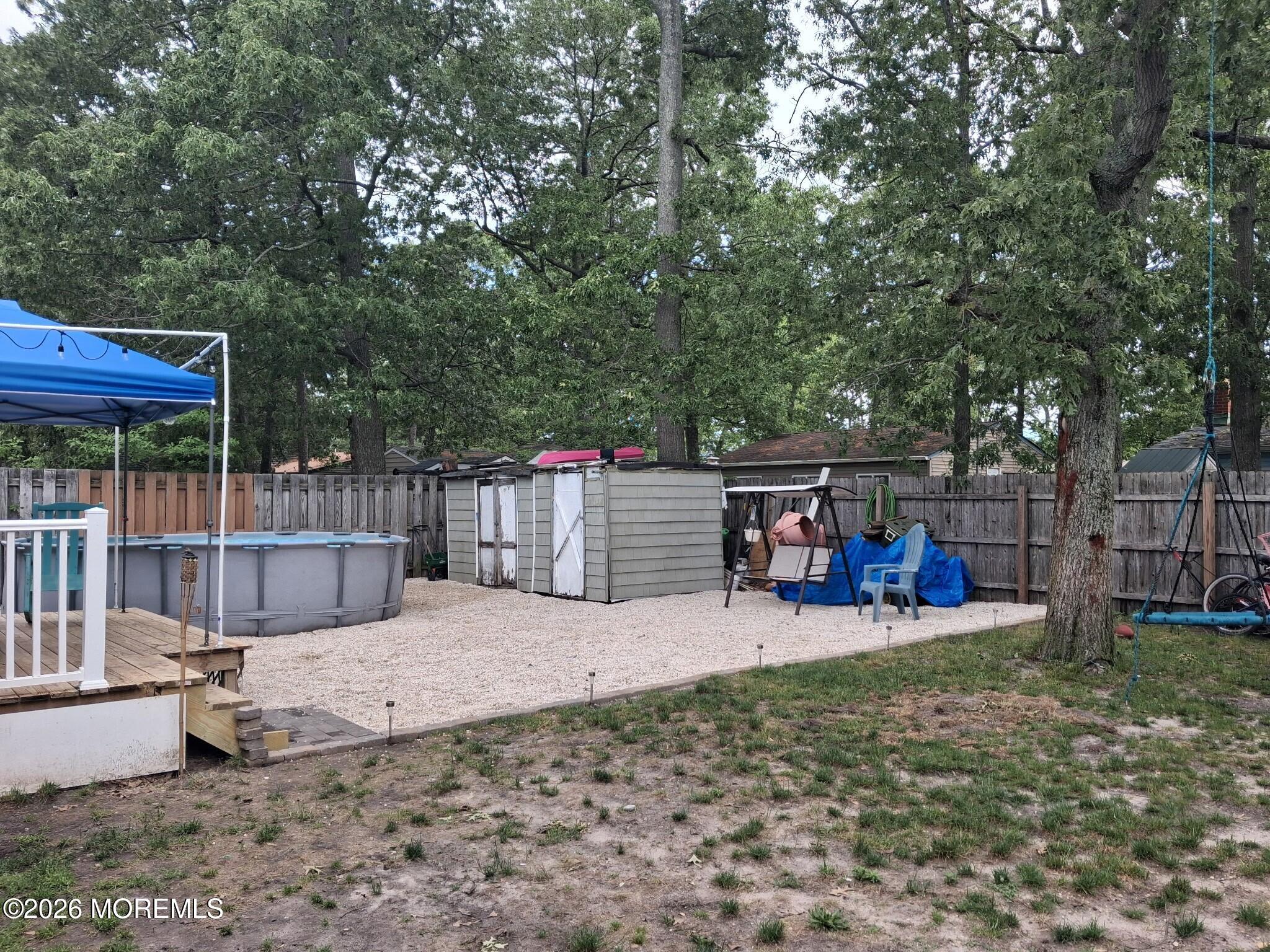 612 Nantucket Road Forked River, NJ 08731 - Photo 20 of 22 a view of a backyard with wooden fence and a large tree