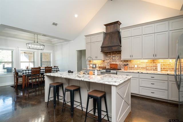 2151 Byrd Road Jacksonville, TX 75766 - Photo 11 of 40 a kitchen with stainless steel appliances granite countertop a stove a sink dishwasher and a refrigerator with wooden floor