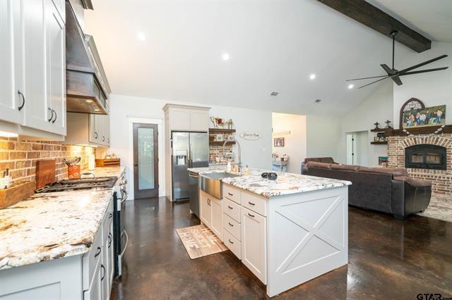 2151 Byrd Road Jacksonville, TX 75766 - Photo 12 of 40 a kitchen with stainless steel appliances kitchen island granite countertop a sink stove and cabinets