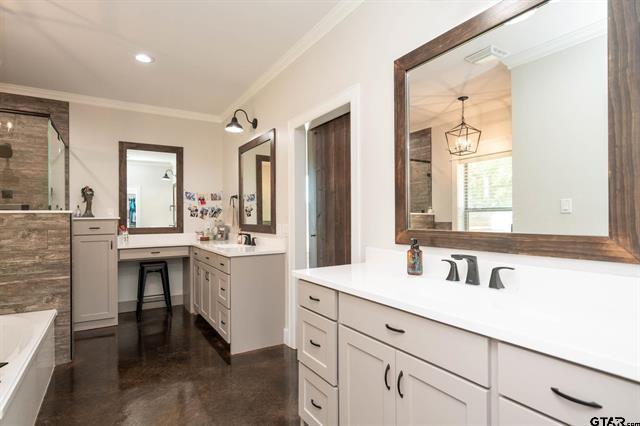 2151 Byrd Road Jacksonville, TX 75766 - Photo 23 of 40 Bathroom with ornamental molding, two vanities, a bathtub, finished concrete flooring, and a shower
