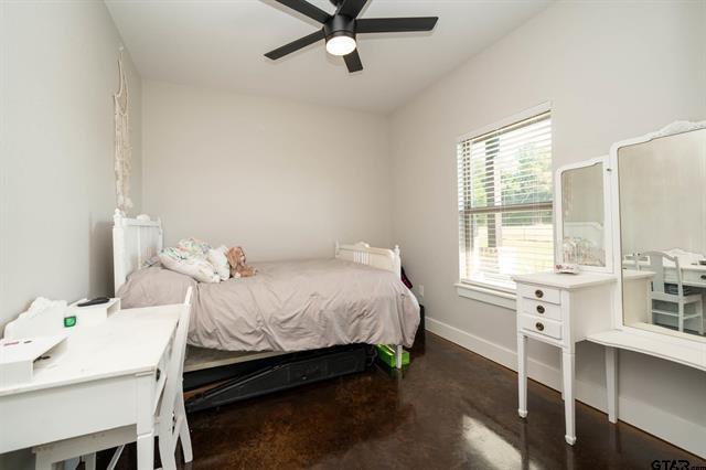 2151 Byrd Road Jacksonville, TX 75766 - Photo 26 of 40 a bedroom with a bed and a table in it
