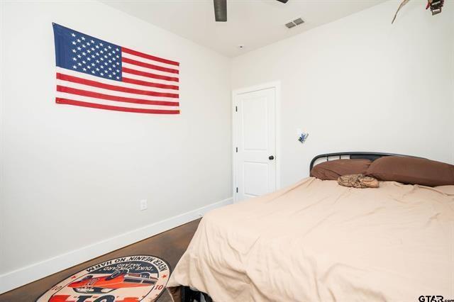 2151 Byrd Road Jacksonville, TX 75766 - Photo 29 of 40 a bedroom with a bed and a chair