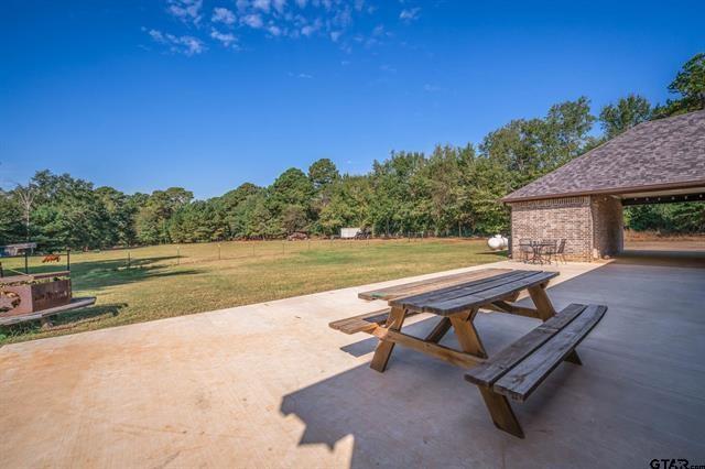 2151 Byrd Road Jacksonville, TX 75766 - Photo 37 of 40 a view of a swimming pool with a lounge chair