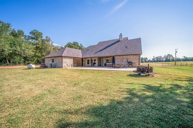 2151 Byrd Road Jacksonville, TX 75766 - Photo 39 of 40 Rear view of house with a lawn, a chimney, and a patio