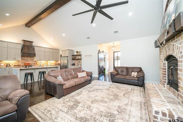 2151 Byrd Road Jacksonville, TX 75766 - Photo 7 of 40 a living room with furniture fireplace and a flat screen tv
