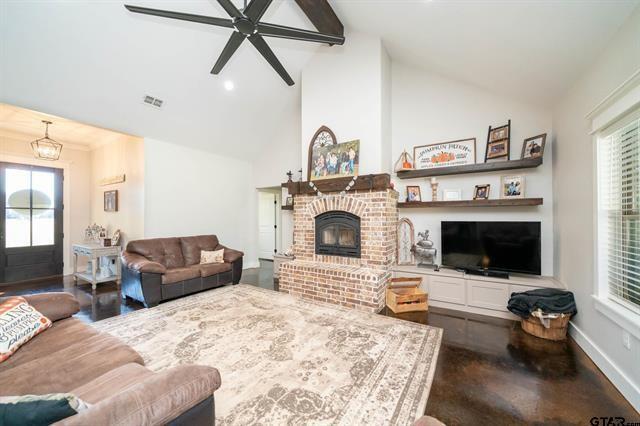 2151 Byrd Road Jacksonville, TX 75766 - Photo 8 of 40 a living room with furniture a fireplace and a flat screen tv