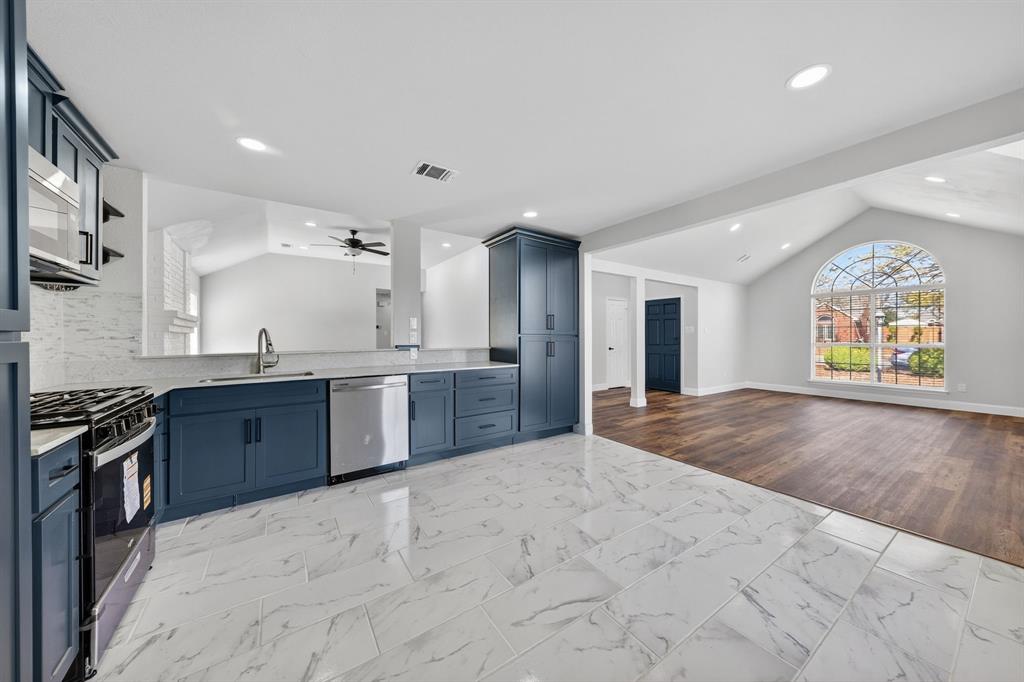 607 Rawlins Drive Lancaster, TX 75146 - Photo 26 of 26 a large kitchen with stainless steel appliances granite countertop a stove a sink and a refrigerator