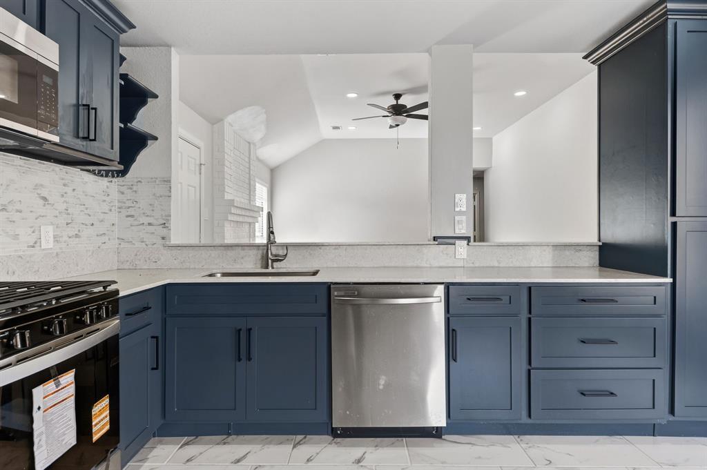 607 Rawlins Drive Lancaster, TX 75146 - Photo 11 of 26 a kitchen with a sink and cabinets