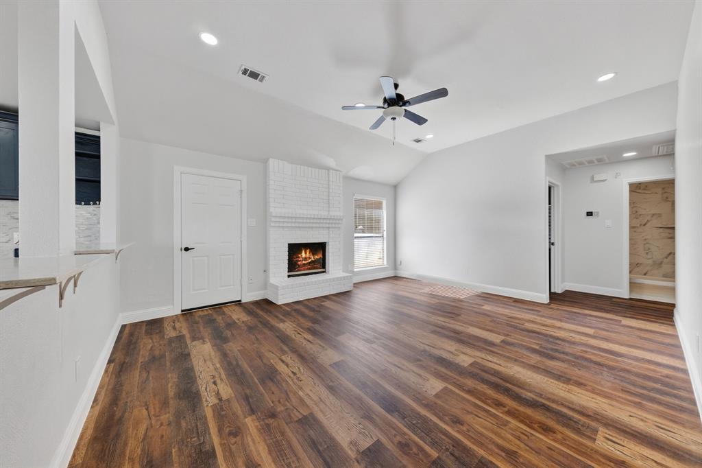 607 Rawlins Drive Lancaster, TX 75146 - Photo 12 of 26 a view of empty room with wooden floor and fireplace