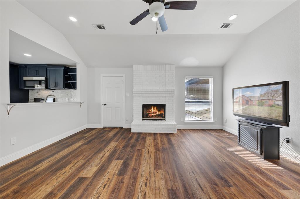 607 Rawlins Drive Lancaster, TX 75146 - Photo 13 of 26 a view of empty room with wooden floor and fireplace