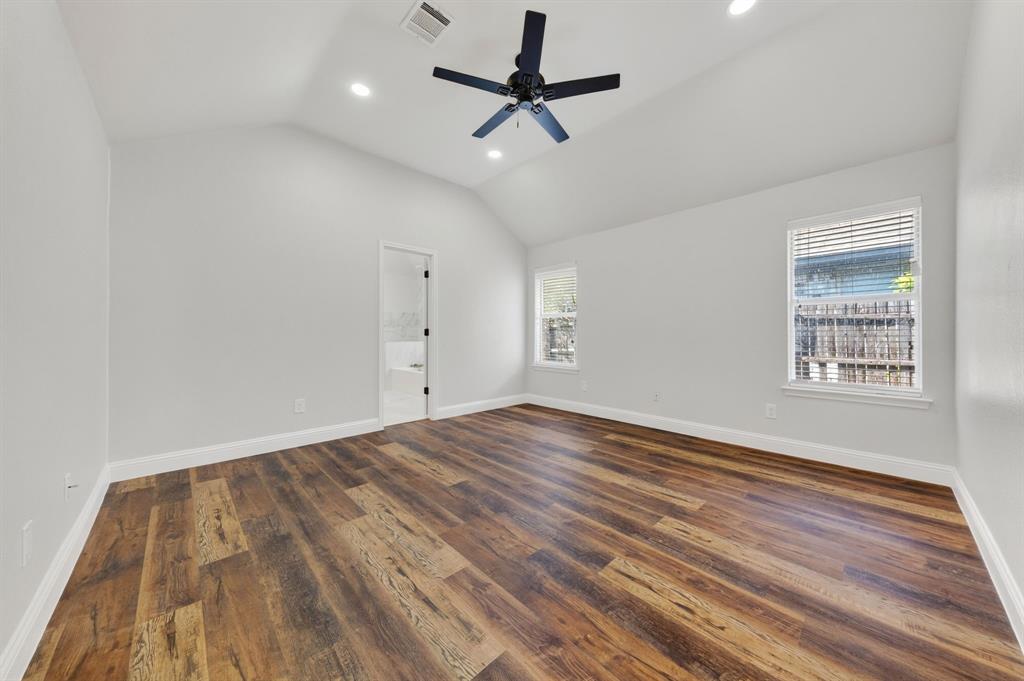 607 Rawlins Drive Lancaster, TX 75146 - Photo 16 of 26 an empty room with wooden floor ceiling fan and windows