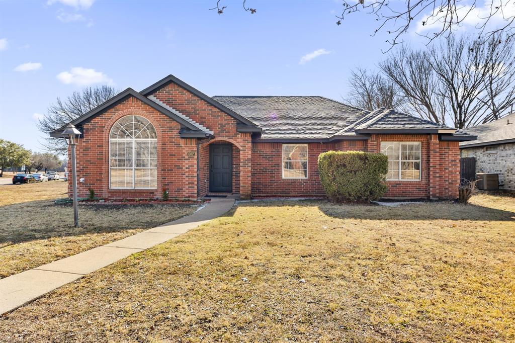 607 Rawlins Drive Lancaster, TX 75146 - Photo 2 of 26 a front view of a house with a yard and garage