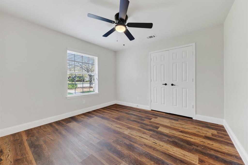 607 Rawlins Drive Lancaster, TX 75146 - Photo 24 of 26 wooden floor in an empty room with a window