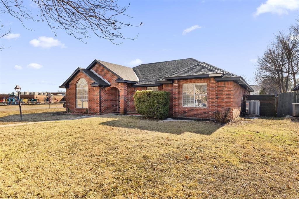 607 Rawlins Drive Lancaster, TX 75146 - Photo 4 of 26 a front view of a house with a yard