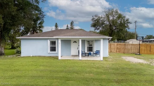 a front view of house with yard and seating area