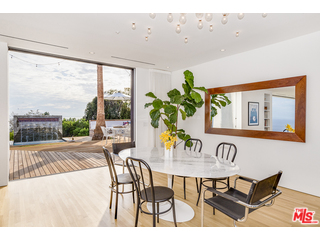 20659 Rockcroft Drive Malibu, CA 90265 - Photo 11 of 33 a view of a dining room with furniture large windows and wooden floor