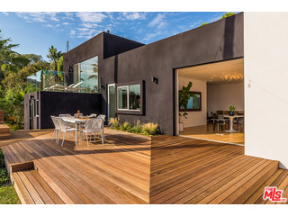 20659 Rockcroft Drive Malibu, CA 90265 - Photo 13 of 33 a view of a patio with table and chairs with wooden floor and fence