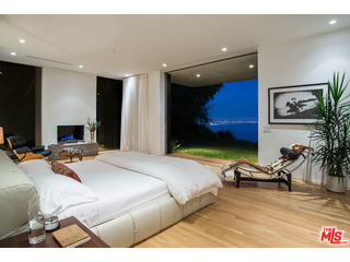 20659 Rockcroft Drive Malibu, CA 90265 - Photo 20 of 33 a bedroom with a bed and a flat screen tv