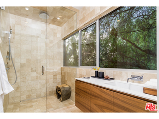 20659 Rockcroft Drive Malibu, CA 90265 - Photo 25 of 33 a bathroom with a sink and a mirror