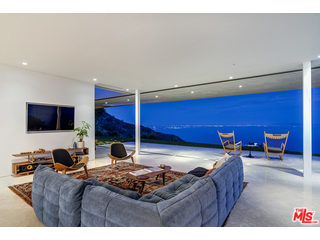 20659 Rockcroft Drive Malibu, CA 90265 - Photo 33 of 33 a living room with furniture a flat screen tv and a refrigerator