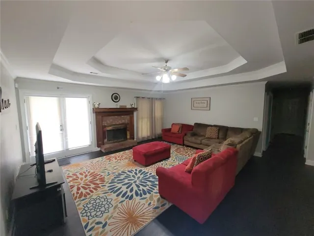 a living room with furniture a fireplace and a flat screen tv