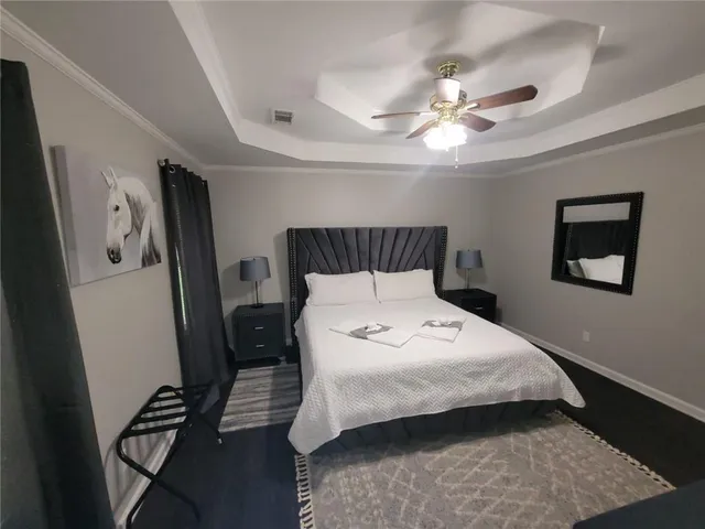 a bedroom with a bed and a chandelier