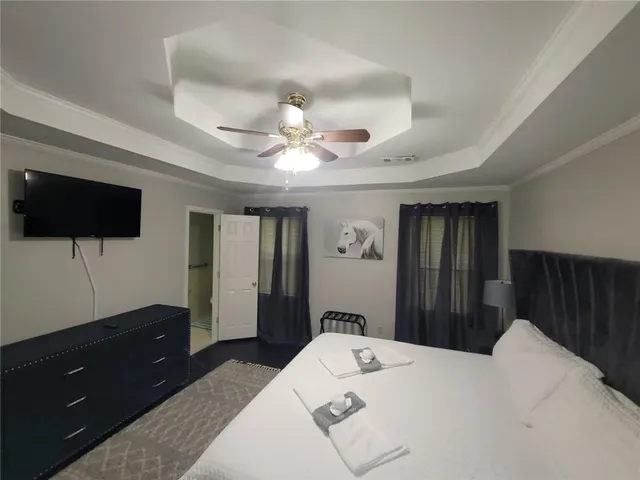 a bedroom with a bed and a flat screen tv