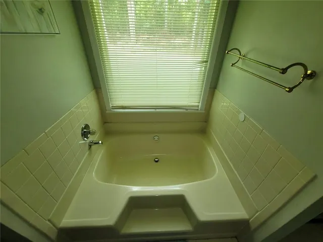 a bedroom with two beds and a chandelier