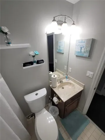 a view of a hallway with wooden floor and closet