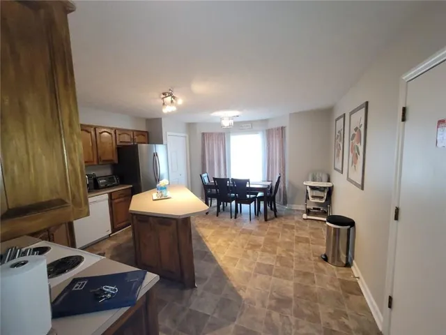 a living room with furniture a dining table and chairs with kitchen view