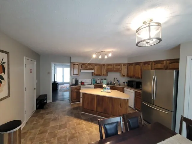 a kitchen with a refrigerator and a sink