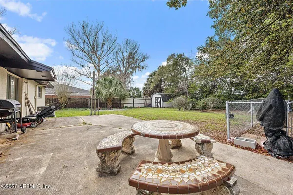 a view of a patio with table and chairs and a fire pit
