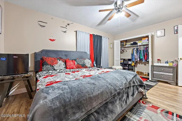 a bedroom that has a bed and a closet