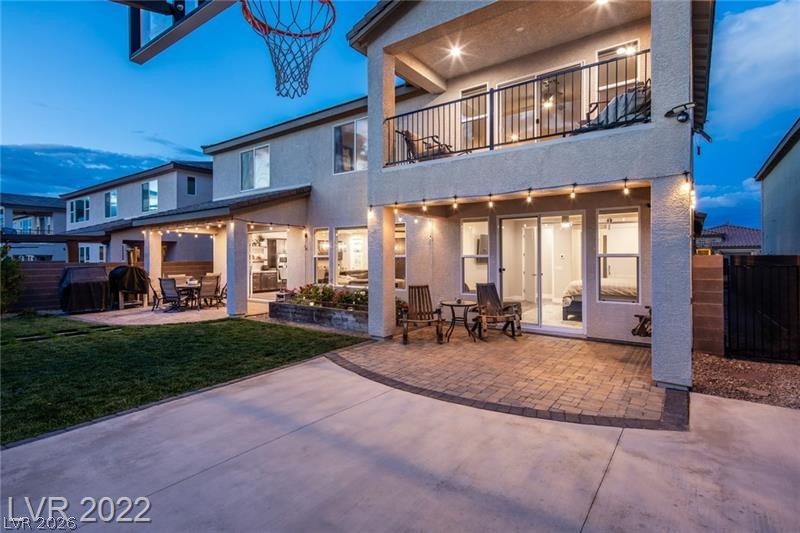 4631 Amazing View Street Las Vegas, NV 89129 - Photo 28 of 33 An inviting backyard oasis offers multiple patio areas for dining and relaxation under string lights.