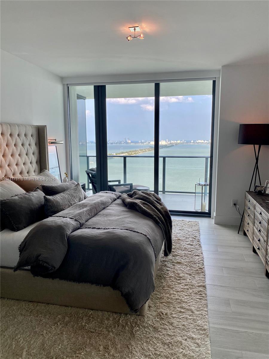 3131 Northeast 7th Avenue, Unit 2801 Miami, FL 33137 - Photo 13 of 47 a bedroom with a bed and a large window