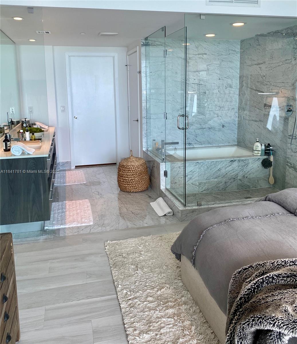 3131 Northeast 7th Avenue, Unit 2801 Miami, FL 33137 - Photo 17 of 47 a bedroom with a bed and a dresser