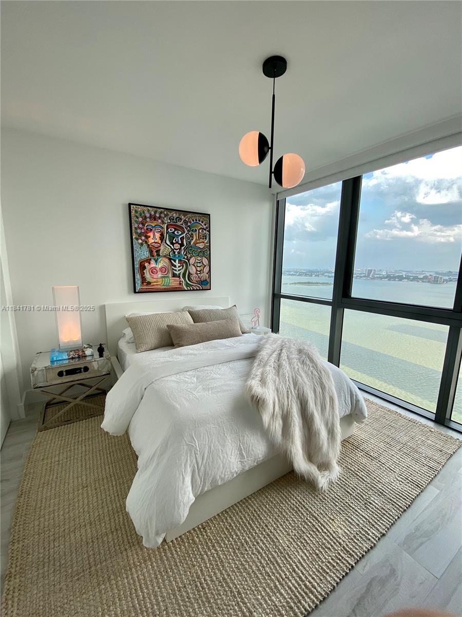 3131 Northeast 7th Avenue, Unit 2801 Miami, FL 33137 - Photo 20 of 47 a bedroom with a large bed and a large window