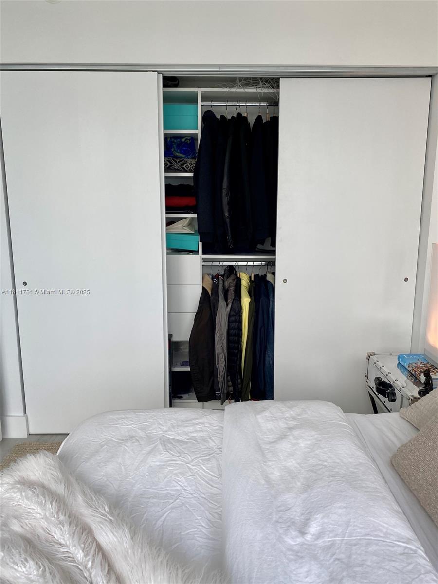 3131 Northeast 7th Avenue, Unit 2801 Miami, FL 33137 - Photo 21 of 47 a bedroom with a bed and a walk in closet