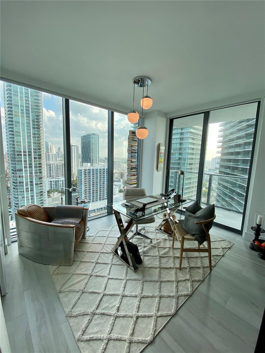 3131 Northeast 7th Avenue, Unit 2801 Miami, FL 33137 - Photo 25 of 47 a living room with furniture and large windows