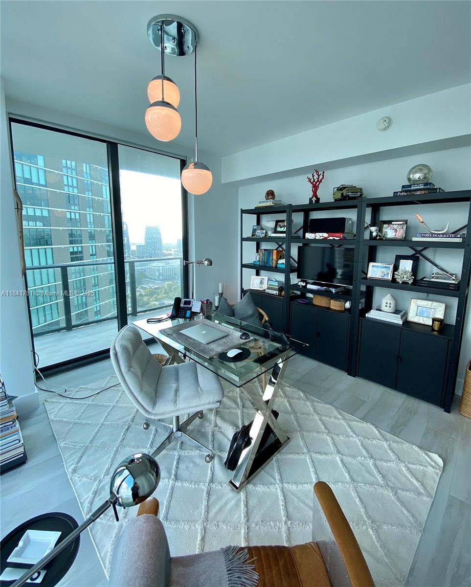 3131 Northeast 7th Avenue, Unit 2801 Miami, FL 33137 - Photo 27 of 47 a living room with furniture and a large window