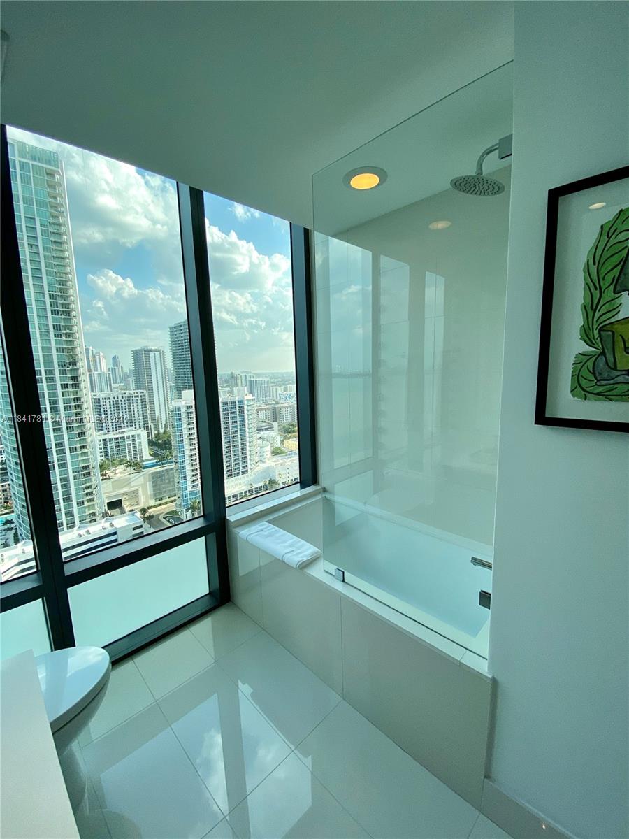 3131 Northeast 7th Avenue, Unit 2801 Miami, FL 33137 - Photo 28 of 47 a bathroom with a bathtub and a shower