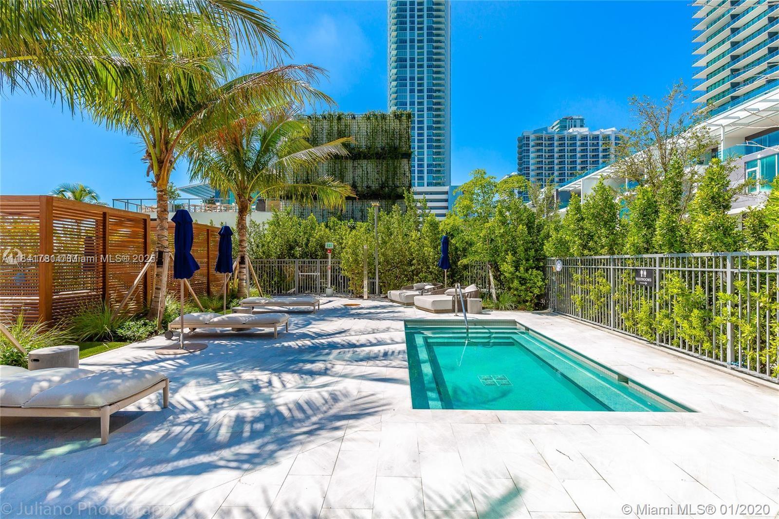 3131 Northeast 7th Avenue, Unit 2801 Miami, FL 33137 - Photo 31 of 47 a view of a swimming pool with a lounge chairs