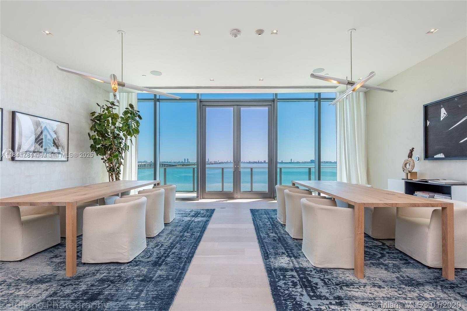 3131 Northeast 7th Avenue, Unit 2801 Miami, FL 33137 - Photo 46 of 47 a living room with a couch and a chandelier