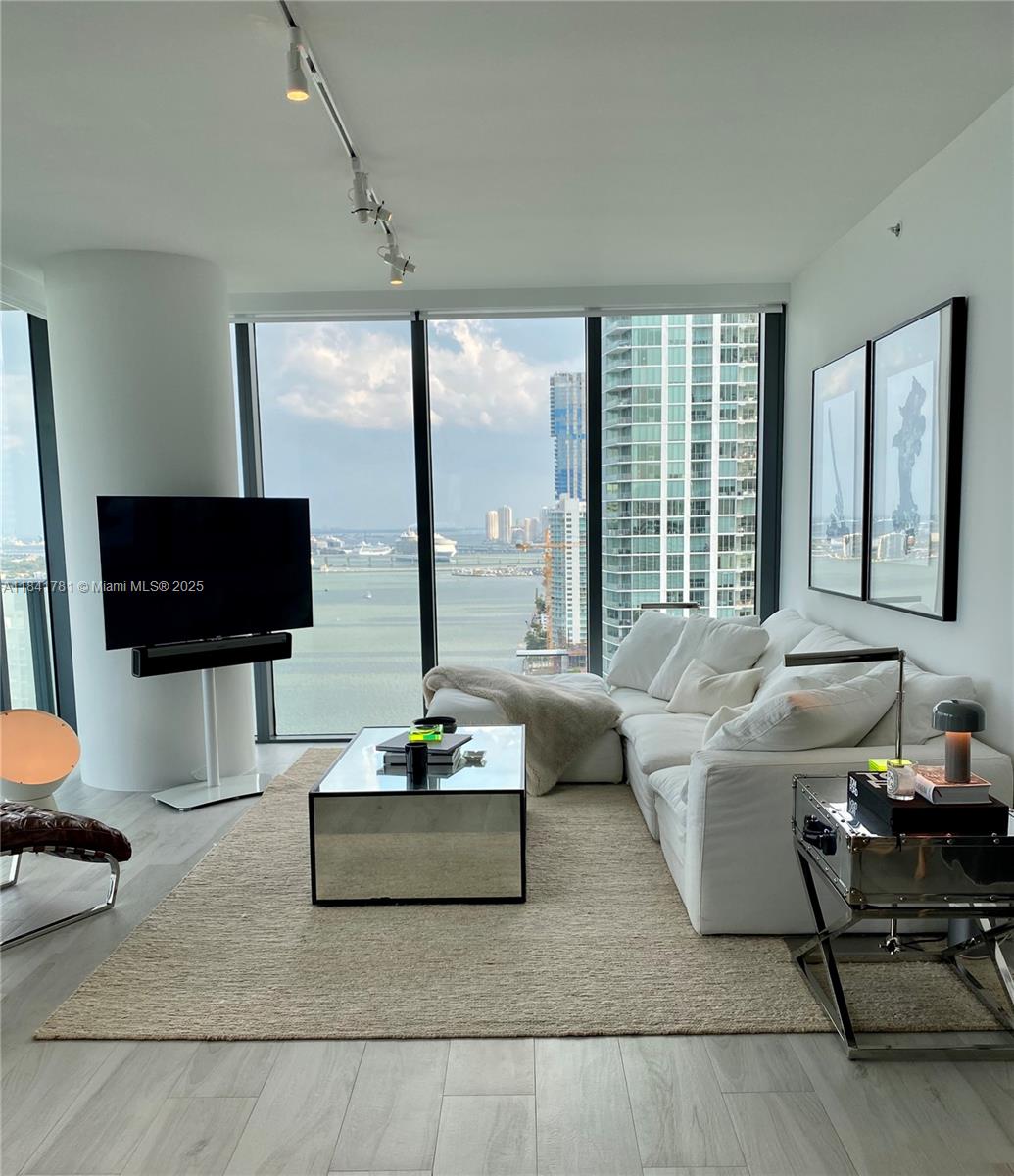 3131 Northeast 7th Avenue, Unit 2801 Miami, FL 33137 - Photo 6 of 47 a living room with furniture and a flat screen tv
