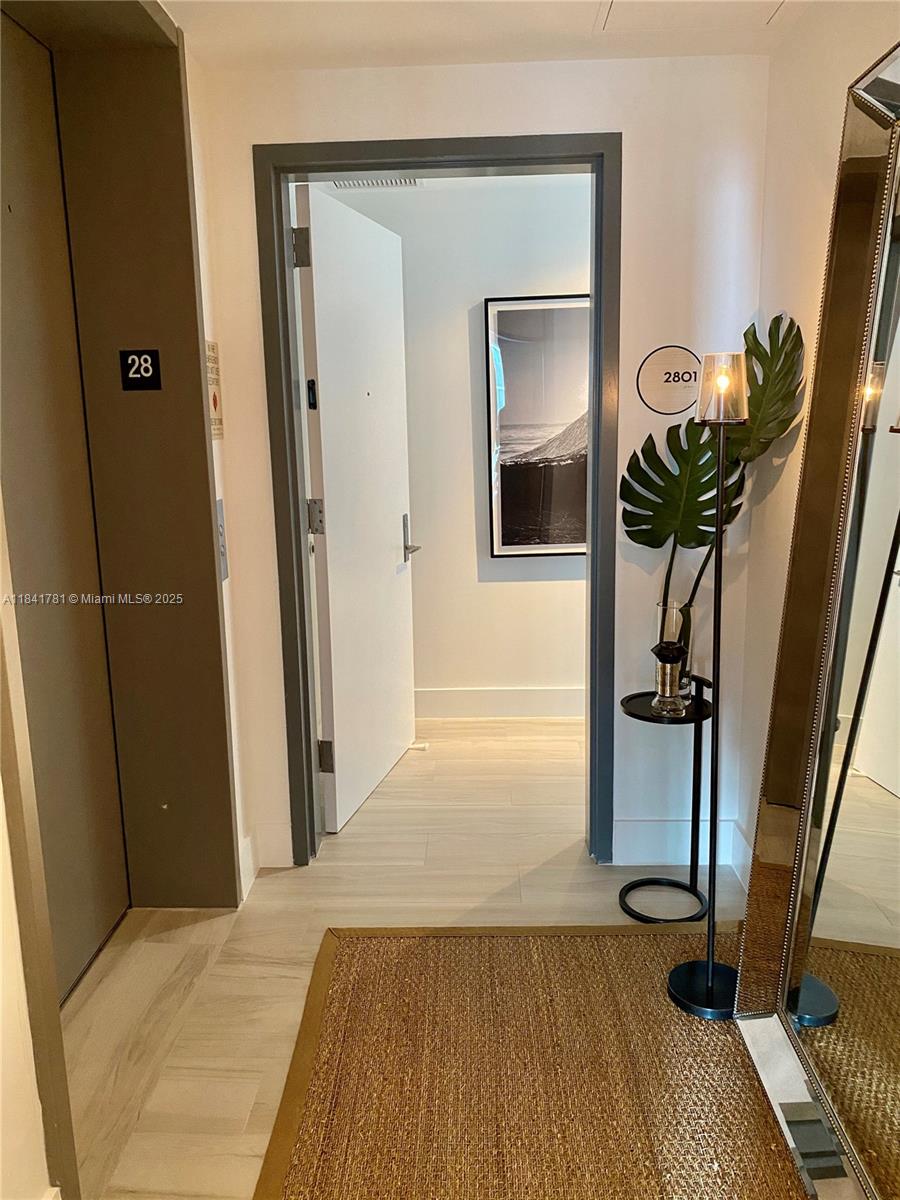 3131 Northeast 7th Avenue, Unit 2801 Miami, FL 33137 - Photo 7 of 47 a bedroom with a bed and a potted plant