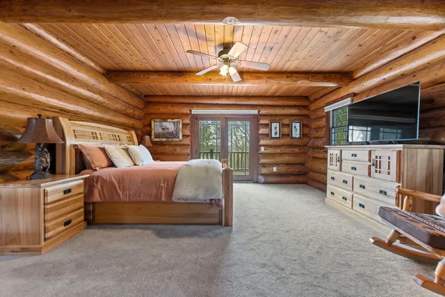 a bedroom with furniture and a flat screen tv