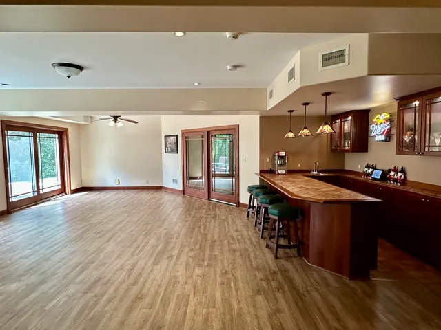 an open kitchen with a sink and breakfast area