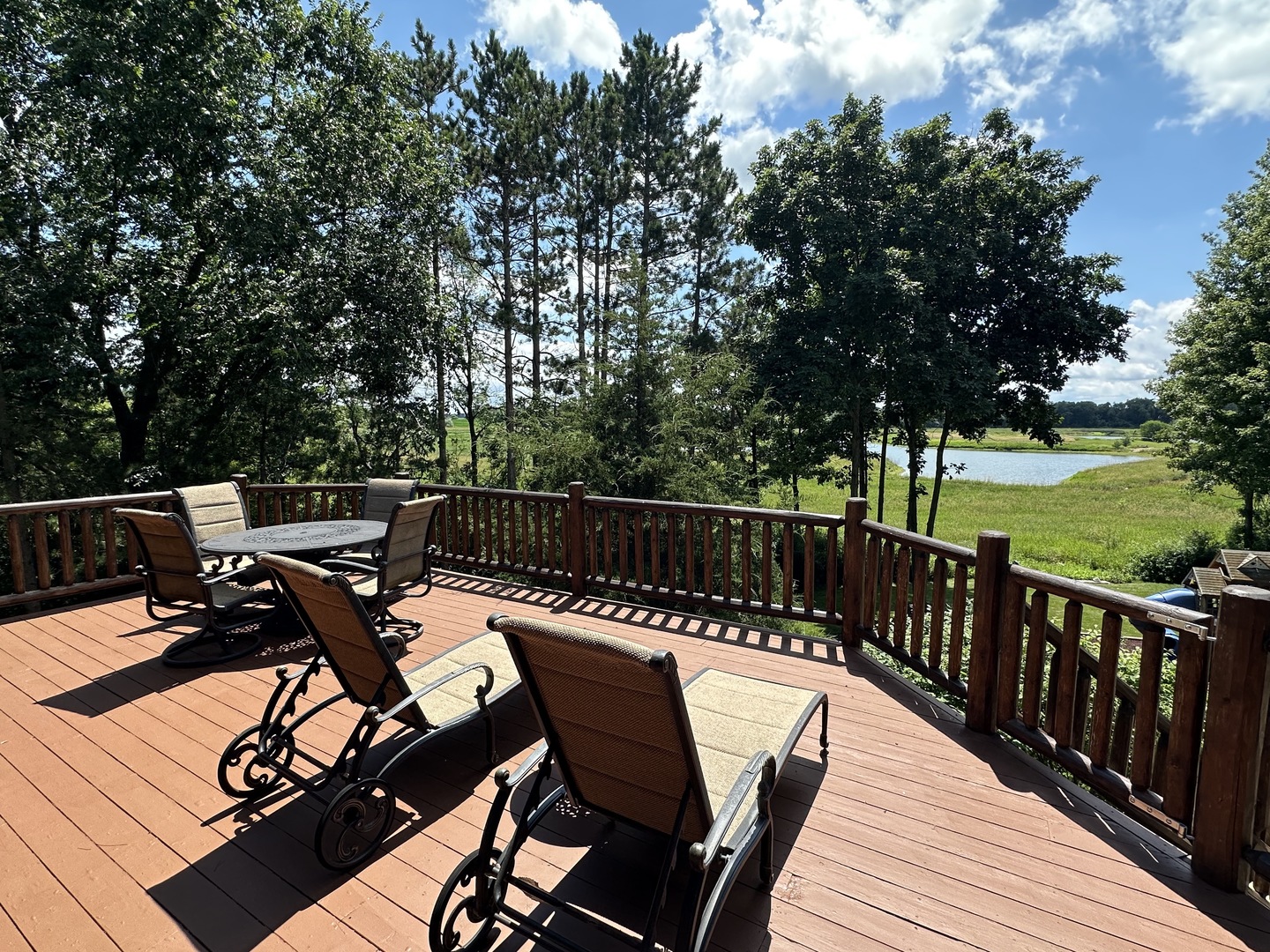 3317 South Country Club Road Woodstock, IL 60098 - Photo 30 of 43 a view of a roof deck with couches and wooden floor